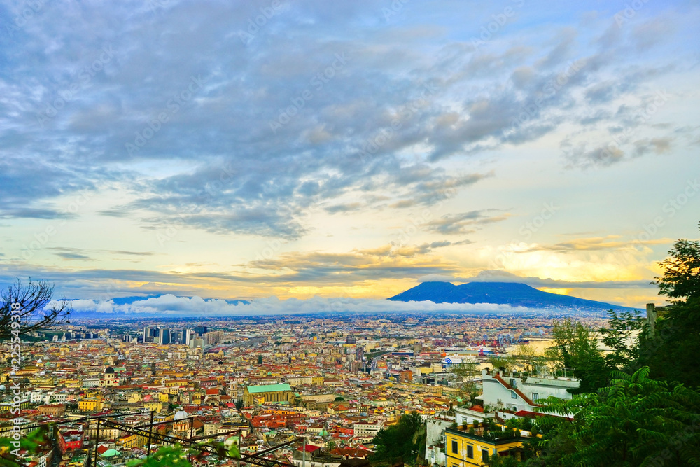 View of the city center of Naples and Mount Vesuvius along the Gulf of Naples at sunset in Naples, Italy.