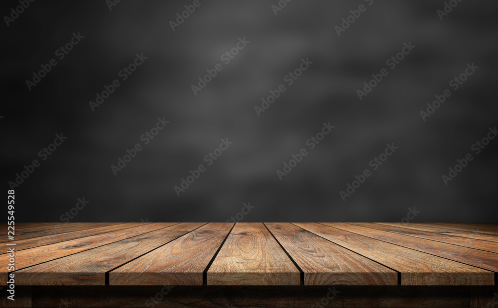 Wooden table with dark blurred background. Stock Photo | Adobe Stock
