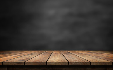 Wooden table with dark blurred background.