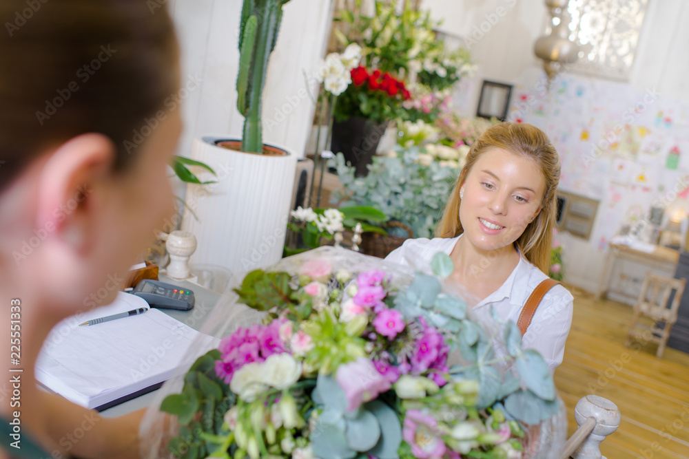 florist giving bouquet to client