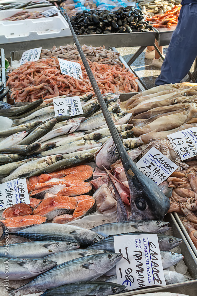 Naklejka premium Asprovalta, Greece - August 13, 2018: Selling fresh fish and squid on public market