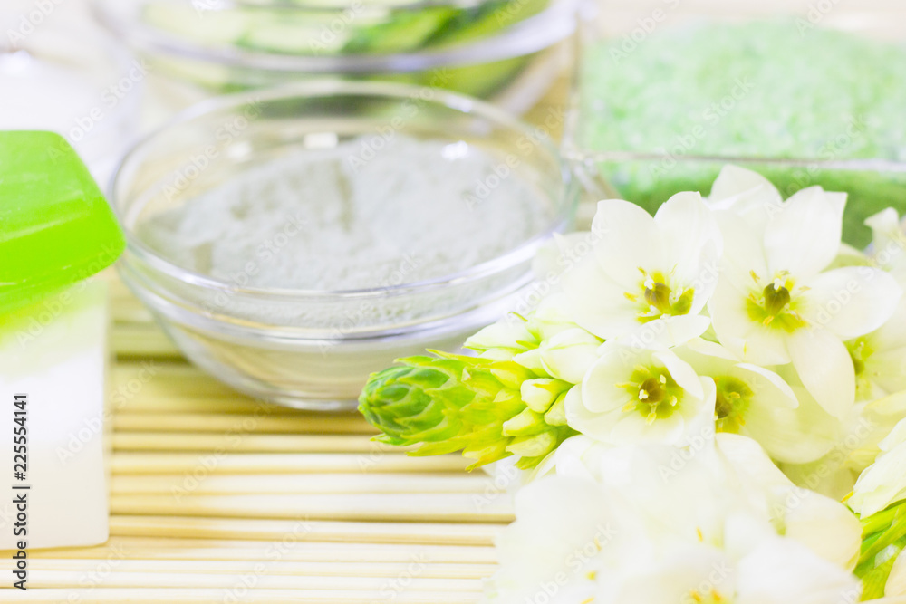 Cucumber home spa and hair care concept. Sliced cucumber, bottles of oil, sea salt, bathroom towel. Straw light background Cucumber home spa and hair care concept. Sliced cucumber, bottles of oil, sea salt, bathroom towel. Straw light background