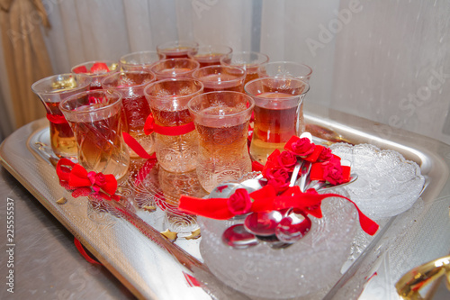 Bild auf Leinwand Set of traditional tea in eastern glass on the silver salver on the white tablec