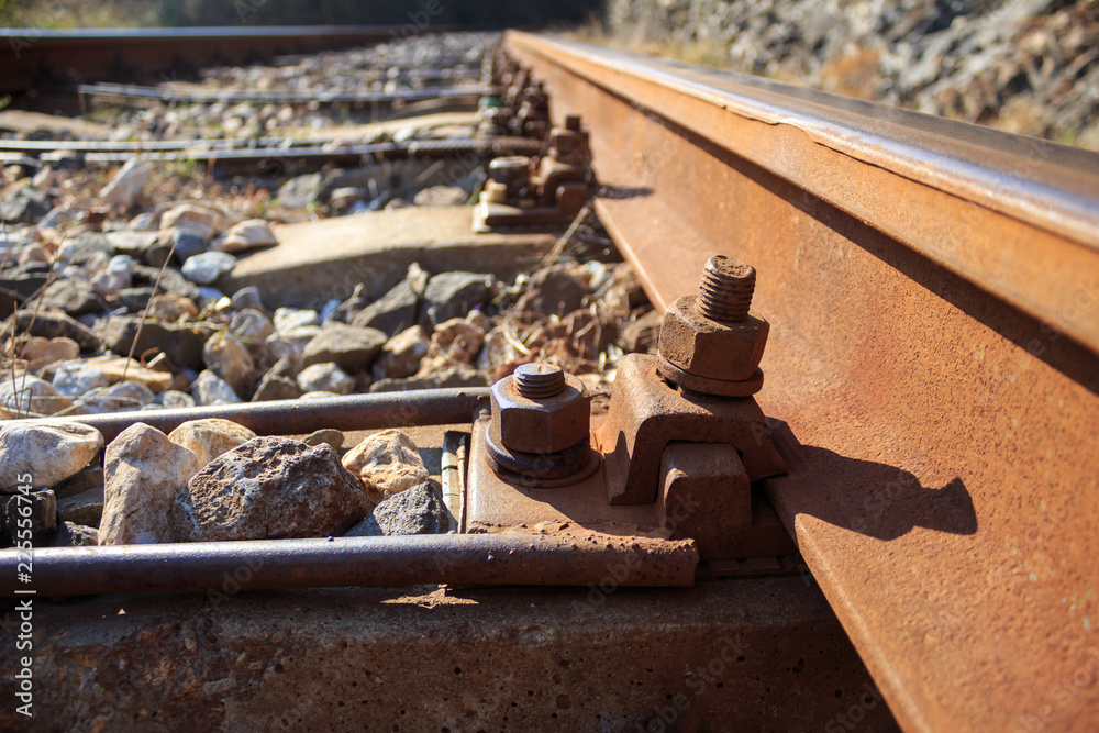 Old aged nuts and bolts on railroad concrete sleepers Old aged nuts and bolts on railroad concrete sleepers