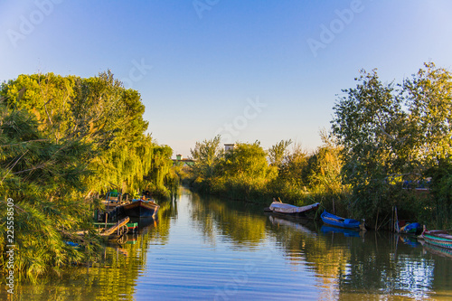 Εκτύπωση καμβά Pier and fishing boats in La Albufera lagoon, at sunset, in Valencia, Spain