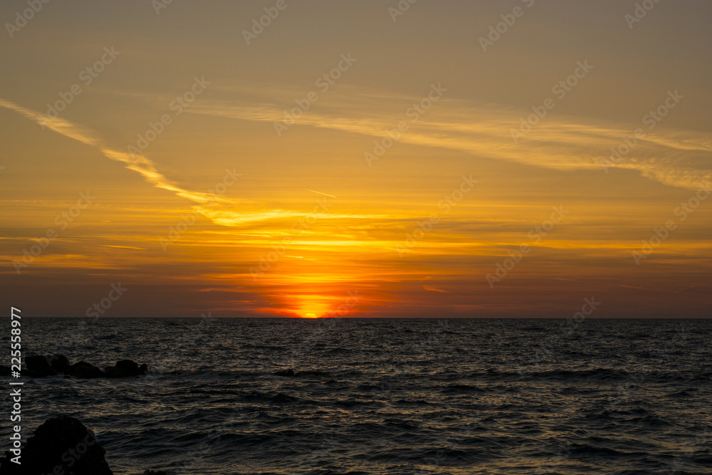 Fototapeta premium bright pink and orange sunset on the background of the sea in Corfu, Greece