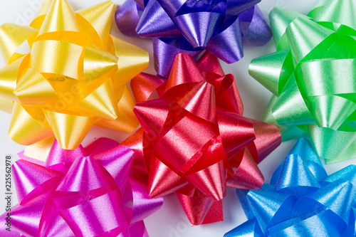 Pink,yellow,red,green,blue and purple gift wrap bows top closeup view on white background