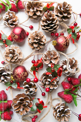 A top view of  mixed golden and red christmas ornaments on red background