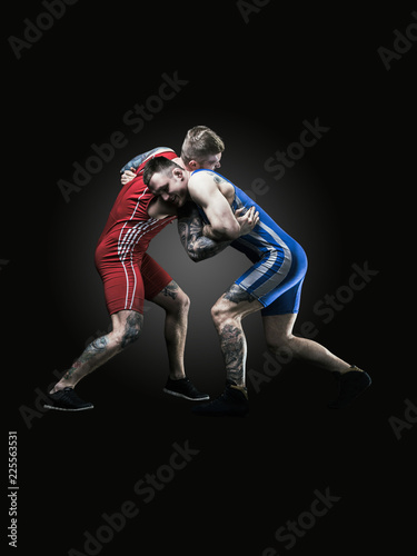 two wrestlers figting isolated on black back © masisyan