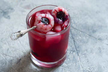 Red halloween cocktail with eye