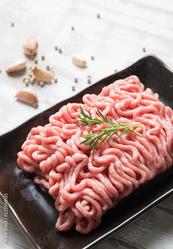 Raw minced pork uncooked with garlic black pepper on wood table,Top view. photo