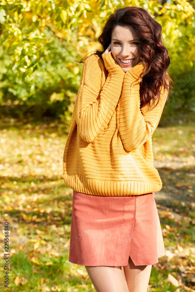 Autumn woman in autumn park. Warm sunny weather. Fall concept Autumn woman in autumn park. Warm sunny weather. Fall concept