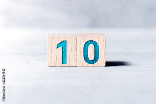 Number 10 Formed By Wooden Blocks On A White Table photo