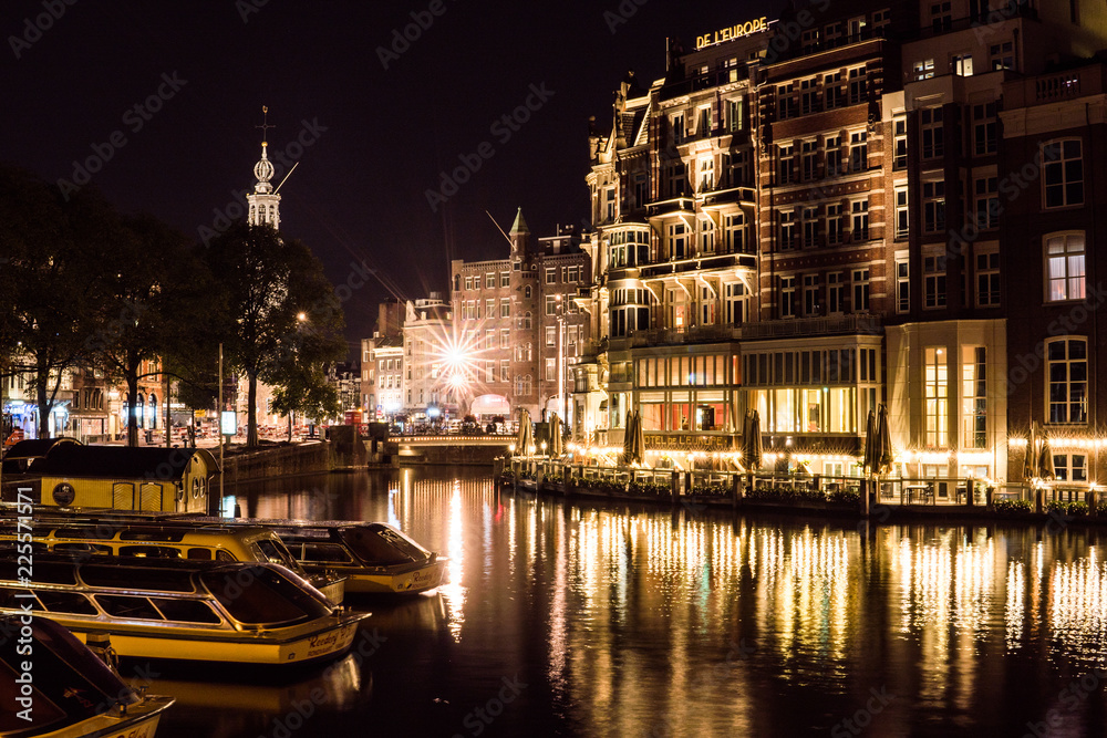 Night city view of Amsterdam channel and typical dutch houses, Holland, Netherlands.