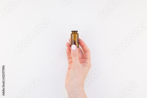 Canvas Print Woman hand with small glass bottle isolated
