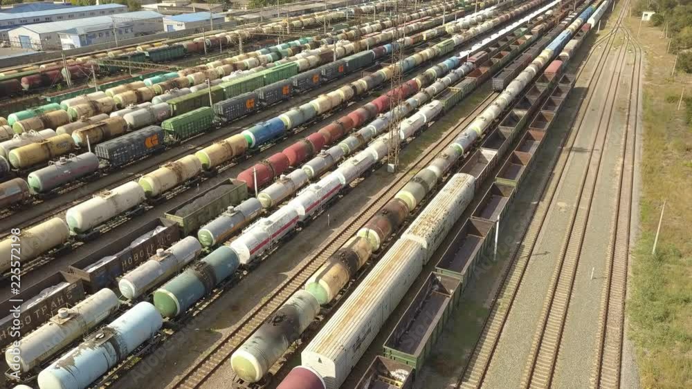 aerial top view of industrial cargo trains on a railway tracks