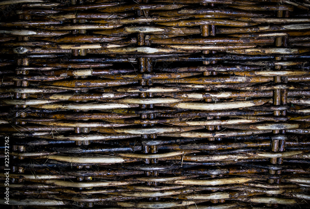Textured lattice background, old wicker fence of willow twigs. Abstract background.