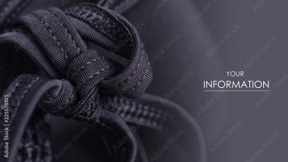 Obraz premium Black swimsuit bra push up seams of a string laces pattern macro background