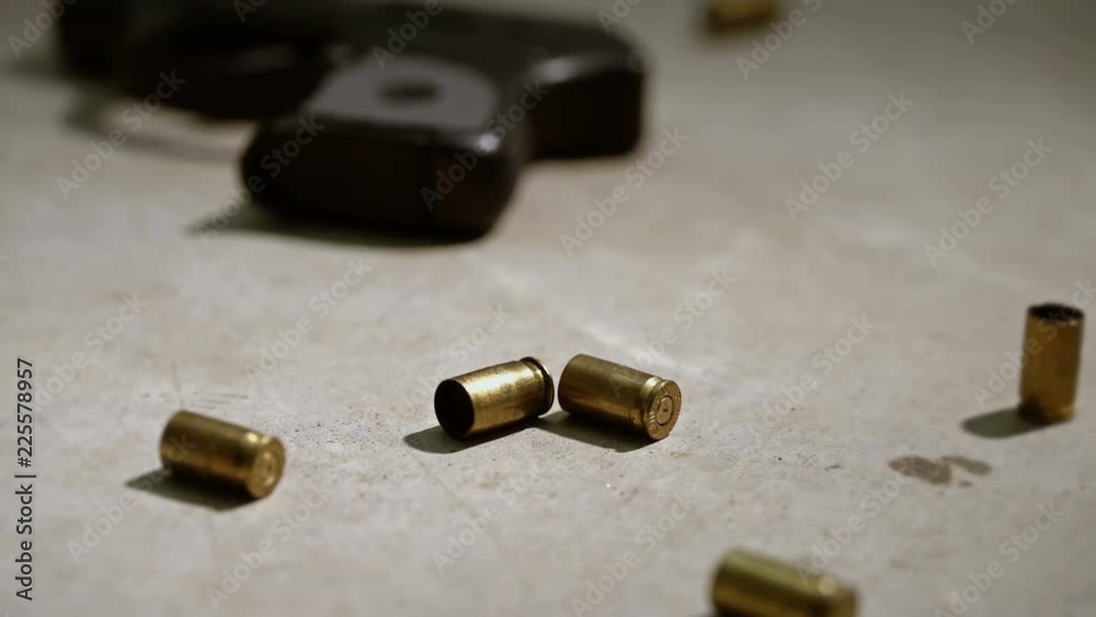 Police crime scene with handgun and bullet casing on the concrete. Police crime scene with handgun and bullet casing on the concrete.