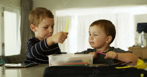 Siblings doing schoolwork in living room 4k