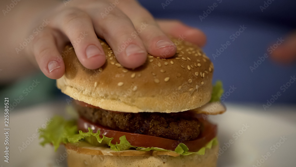 Female preparing to eat unhealthy fatty burger, obesity and overeating problem Female preparing to eat unhealthy fatty burger, obesity and overeating problem
