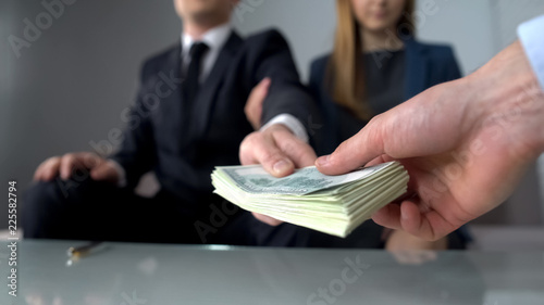 Vászonkép Couple giving bribe for illegal deal on real estate market, inheritance fraud
