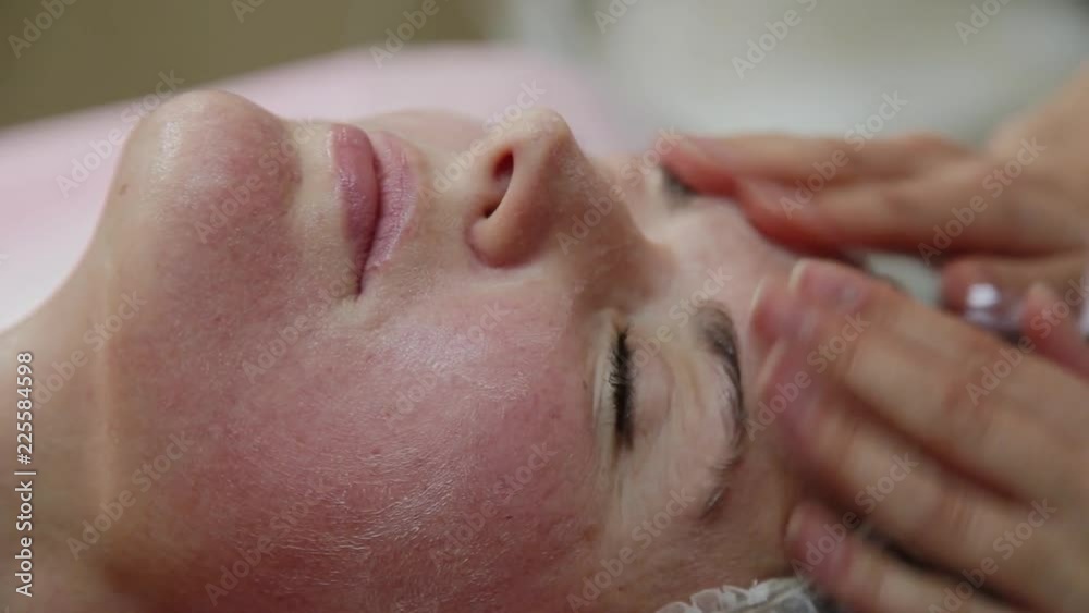 Very beautiful girl doing facial massage at the spa salon. Healthy lifestyle. Very beautiful girl doing facial massage at the spa salon. Healthy lifestyle.