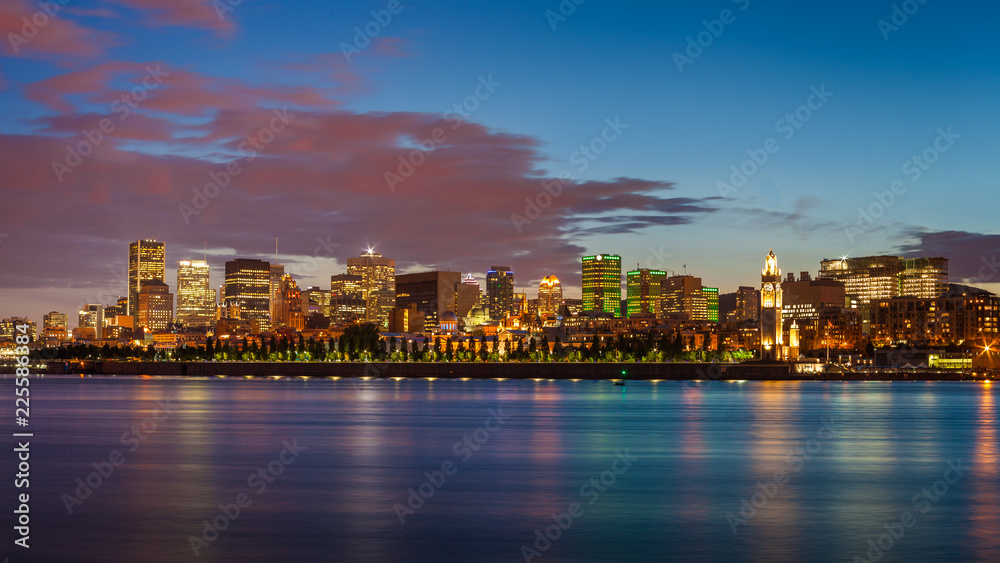 Montreal city skyline over Saint Lawrence River at twilight with urban buildings, Montreal, Quebec, Canada