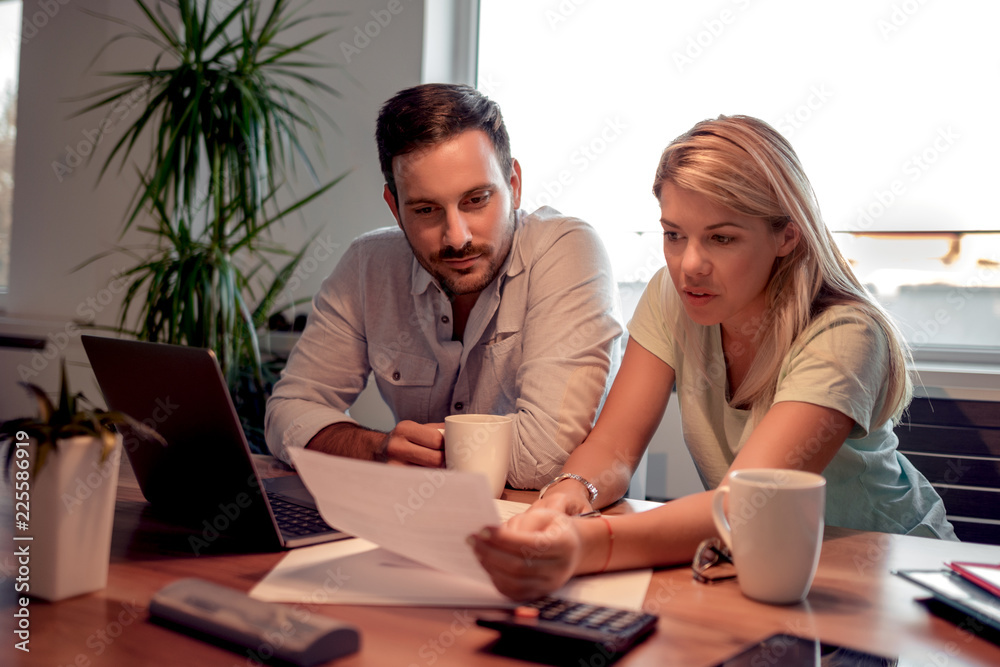 Couple checking their bills at home Couple checking their bills at home