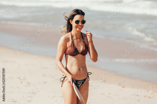 Young woman playing tennis on the beach