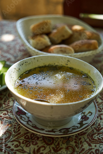 Traditional Azerbaijan dushbere soup with meat dumplings and fresh vegetable sliced tomatoes, cucumbers and pita bread