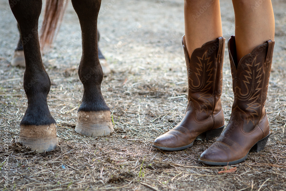 Horse hooves and cowboy boots