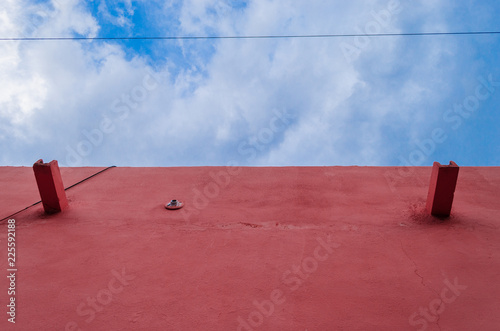 Wall of a pink house, on a blue sky
