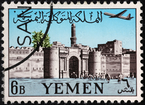 Ancient town gate on old yemeni postage stamp photo