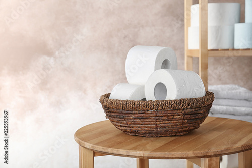 Bowl with toilet paper rolls on table indoors. Space for text photo
