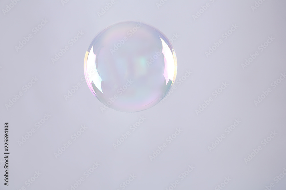 Beautiful translucent soap bubble on grey background Beautiful translucent soap bubble on grey background