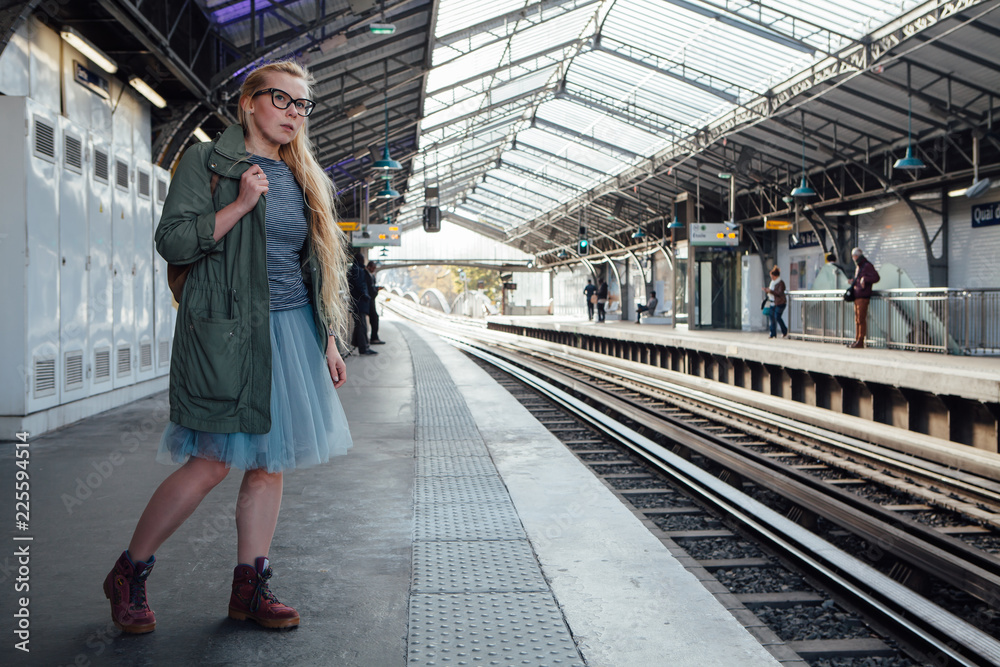 Girl waiting for the train at the metro station in Paris Girl waiting for the train at the metro station in Paris