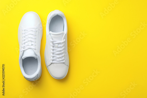Pair of sneakers on color background, flat lay. Space for text