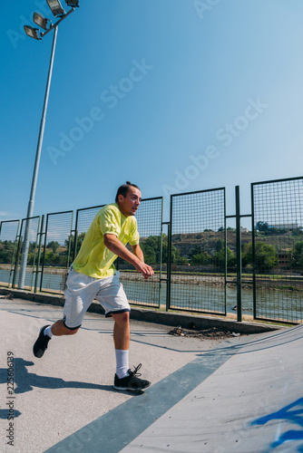 Sportive man in action while jump over obstacles