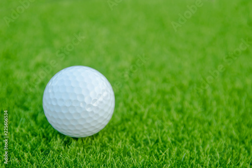 Golf ball on green grass ready to play at golf course. with copy space