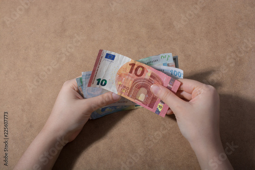 Hand holding American dollar  isolated on wooden background photo