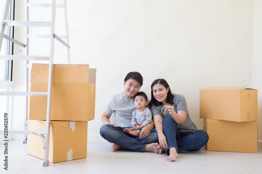 Happy Asian family with cardboard boxes in new house at moving day, Real estate and home concept Happy Asian family with cardboard boxes in new house at moving day, Real estate and home concept