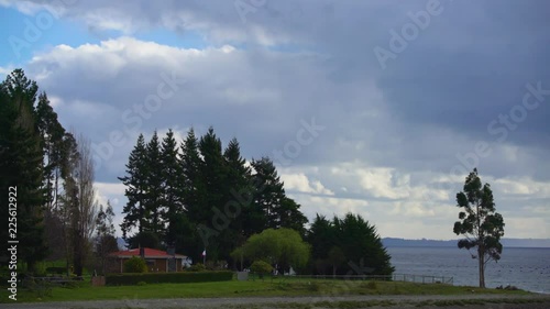Time lapse - house on an island and the clouds advance rapidly carrying water photo