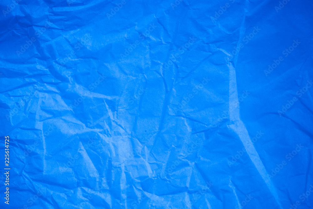 Obraz premium Crumpled blue paper background.