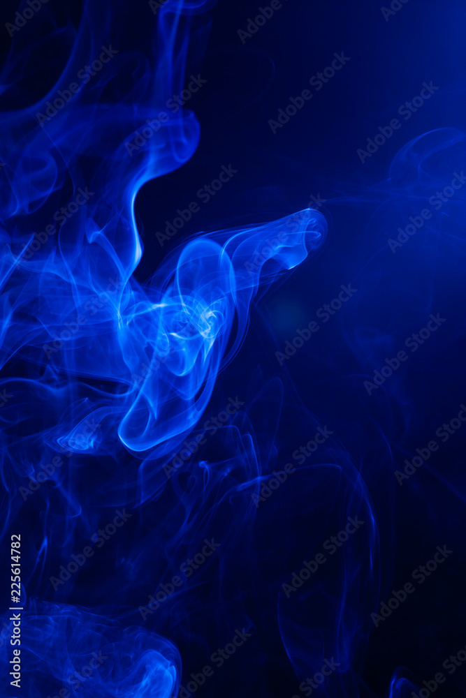 Fototapeta premium Blue smoke on black background.
