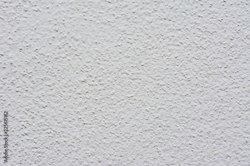 White or grey knobby cement wall texture background.