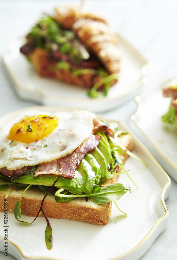 Bacon and avocado toast with croissant sandwich 