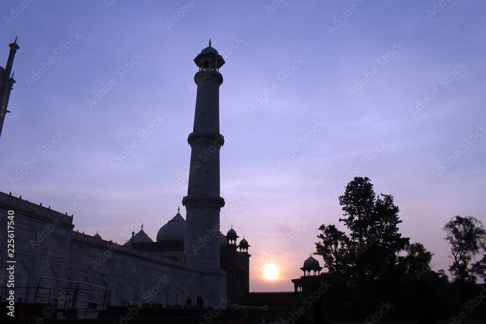 The silhouette of Taj Mahal towers during sunrise