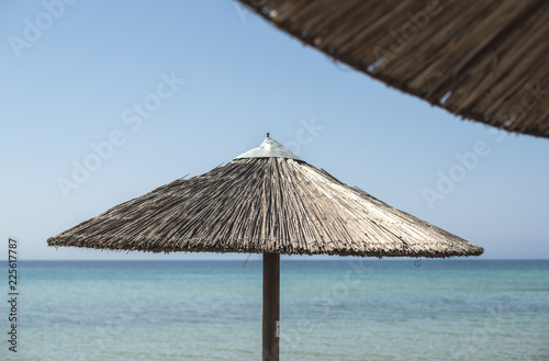 Fototapeta Naklejka Na Ścianę i Meble -  Straw umbrella on the beach
