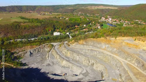 Camera flight over a stone quarry on Berounka river near Zbecno.  Industrial landscape in Czech Republic. Heavy industry from above.  photo